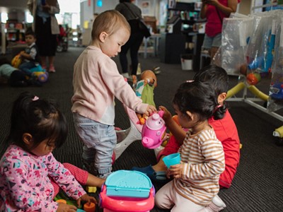 A photo of young children playing with toys at the library