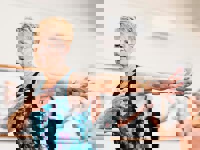 A photo of a woman over 50 in motion at a dance class