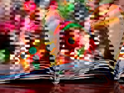 A photo of a book with christmas lights in the background