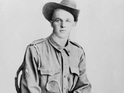 Formal black and white image of a young man in military uniform